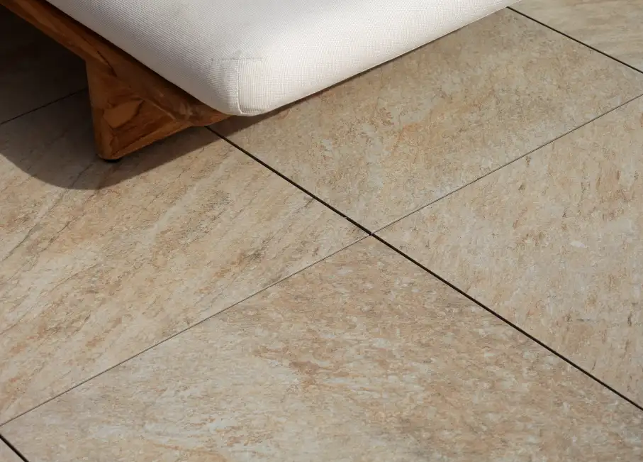 Warm-toned Stone20-PMI® flooring beneath an outdoor bench with a cushion