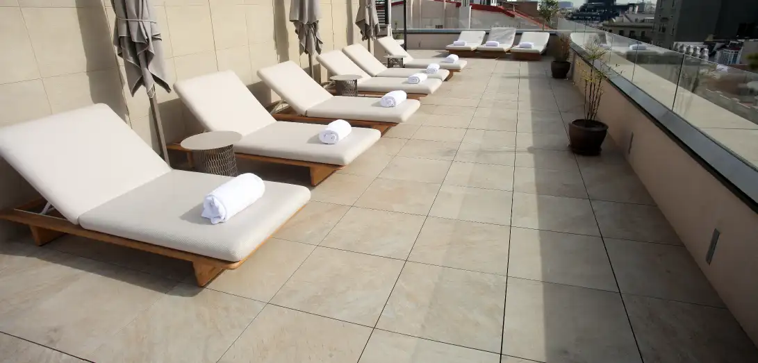 Terraza de hotel con hamacas sobre pavimento Access Safety de gran formato